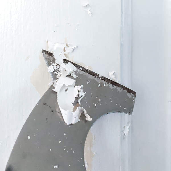 scraping off loose latex paint