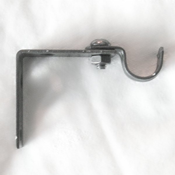 Simple curtain rod brackets using inexpensive hardware from your local home improvement store.