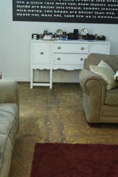 plywood subfloor after removing residue from glued-down carpet.