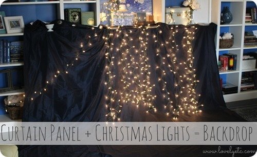photo backdrop made from a curtain panel and Christmas lights.