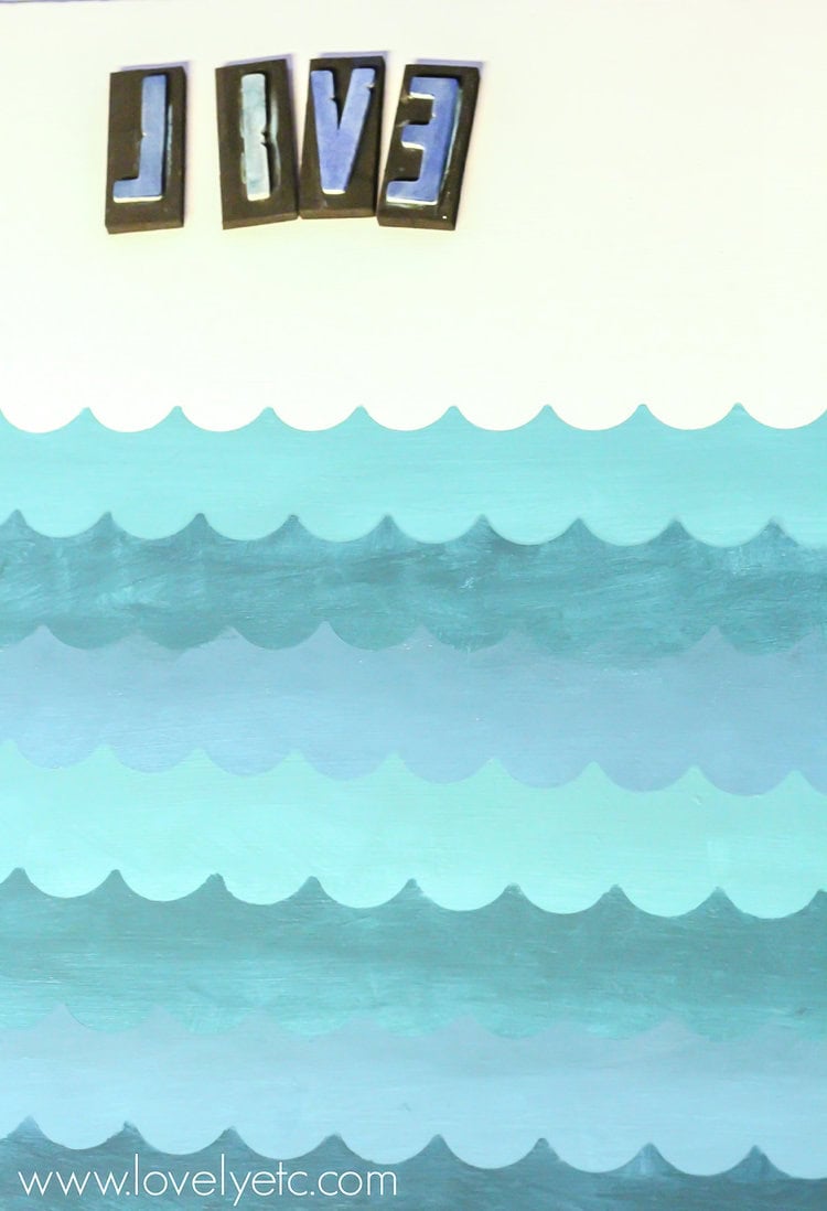 layers of waves painted on sign.