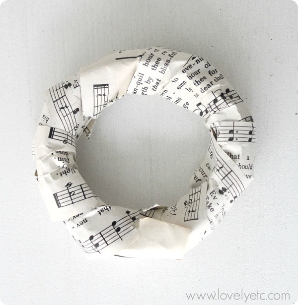 Mini wreath base covered with sheet music.