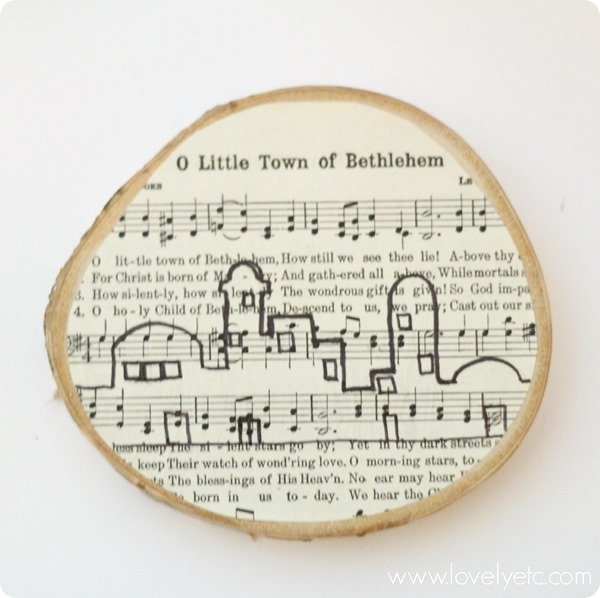 drawing Bethlehem skyline on DIY wood slice ornament.