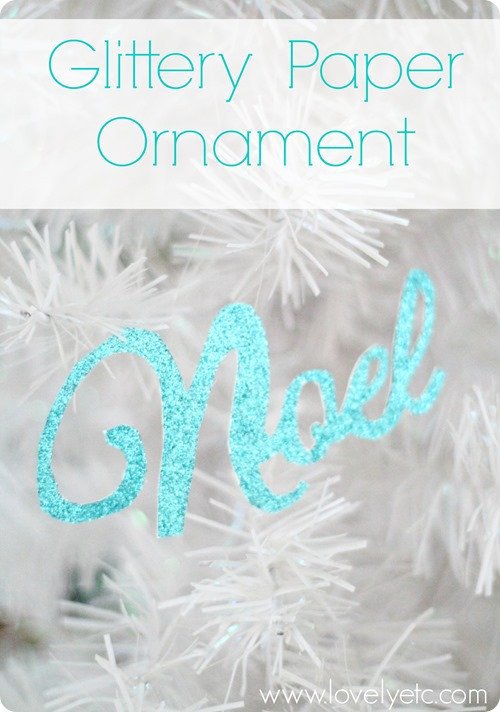 Glittery paper Christmas tree ornament - simple but so glamorous glittery paper ornament that says Noel hanging on white Christmas tree.