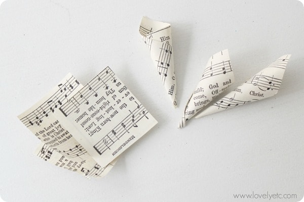 squares of sheet music rolled into tiny cones.