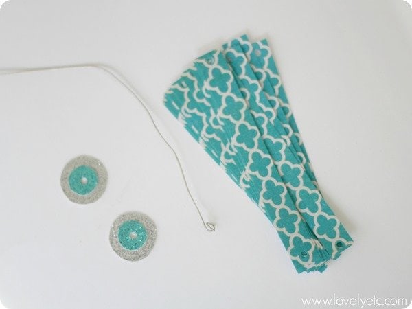 scrapbook paper ornament supplies - strips of paper, craft wire, and circles of card stock.