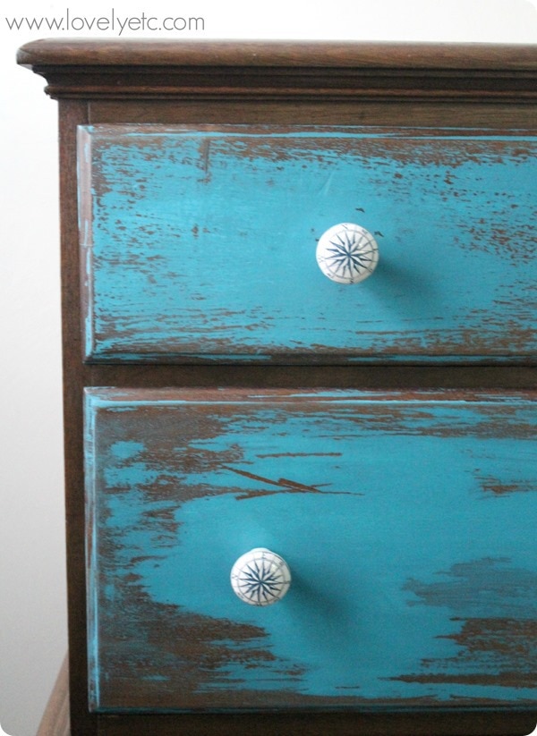 blue dresser with compass knobs