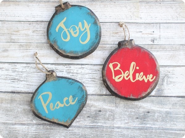 Set of three painted wooden ornaments  with the words Joy, Believe, and Peace.