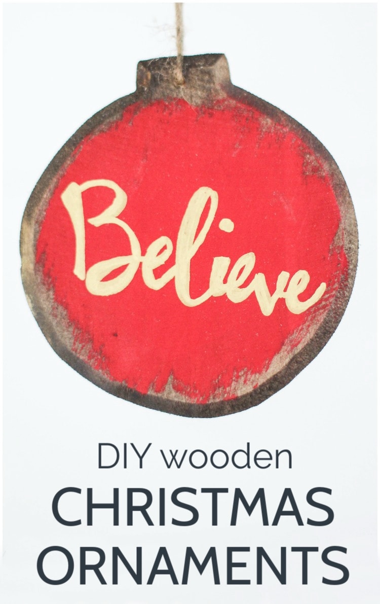 wooden Christmas ornament stained and painted red with the word Believe in gold letters.