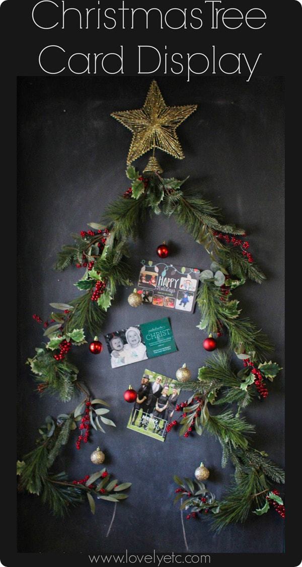 Christmas tree card display on chalkboard.