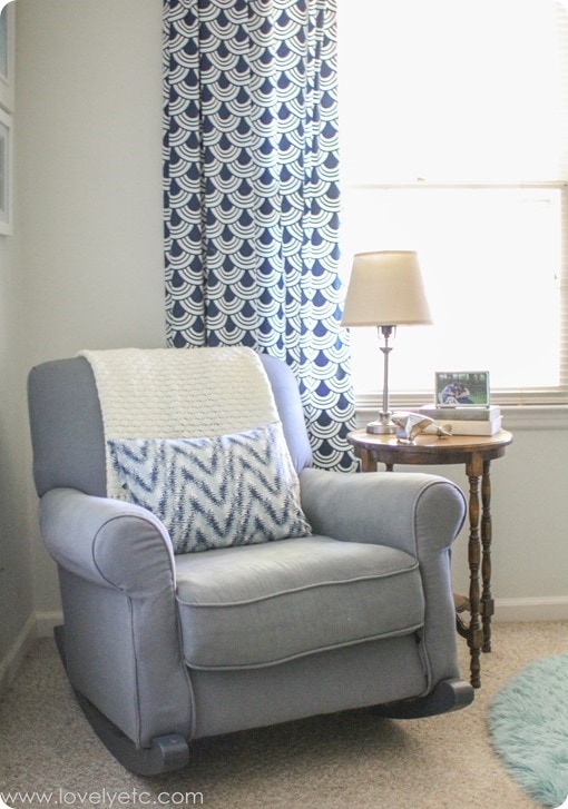 gray glider and navy curtains in nursery