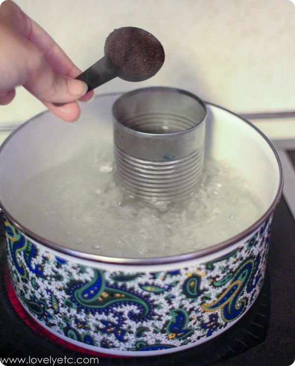 adding coffee to the double broiler to make a coffee scented candle.