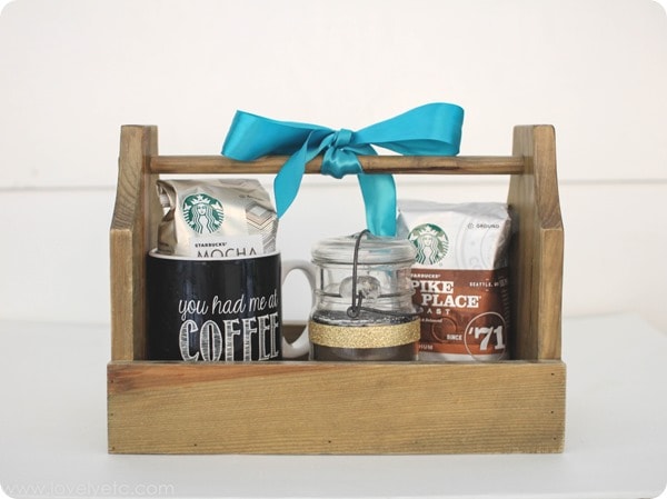 coffee lovers gift basket with coffee mug, bags of coffee, and diy peppermint coffee candle.