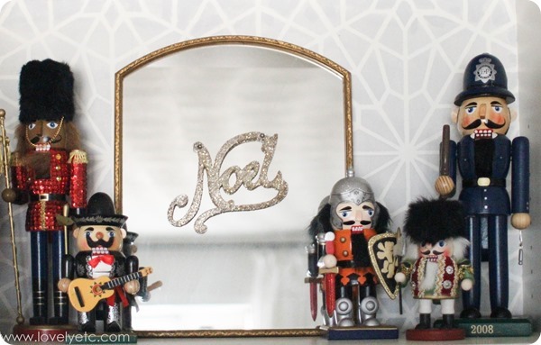 nutcrackers on shelf next to small mirror.