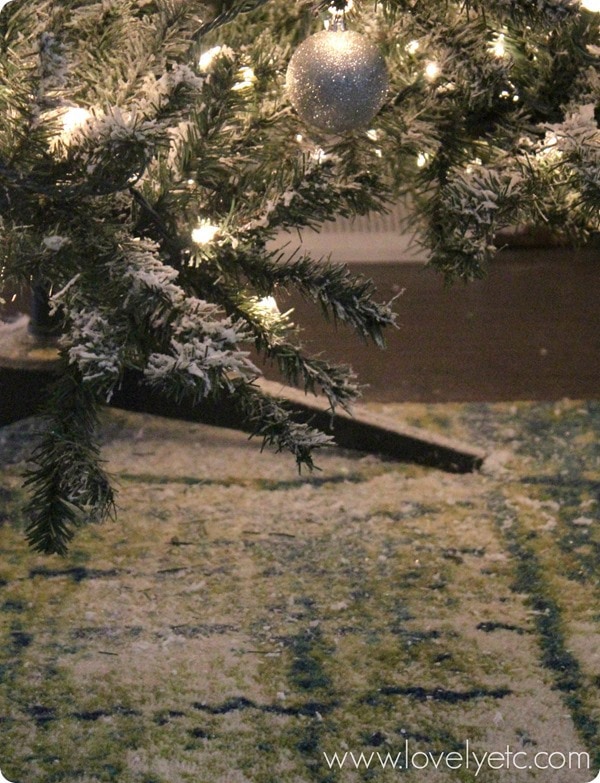 close up of mess on floor after decorating diy flocked Christmas tree.