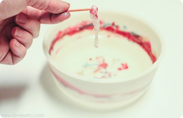 removing the old nail polish from your bowl of water after marbling an ornament.