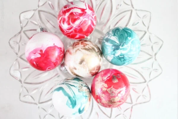 diy marbled ornaments in red and white, blue and white, and gold and white.
