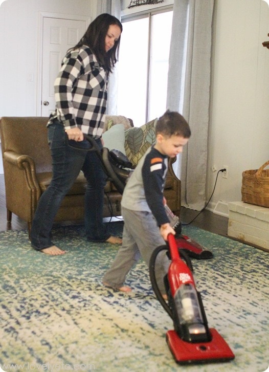 mom and son vacuuming together