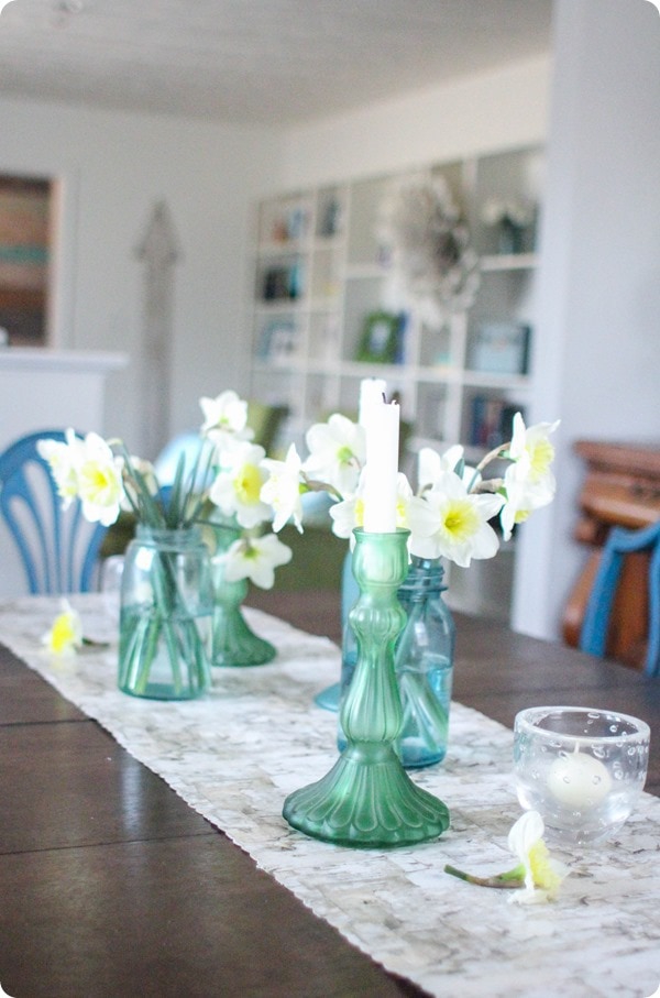 spring table with daffodils in mason jars and cheap table runner