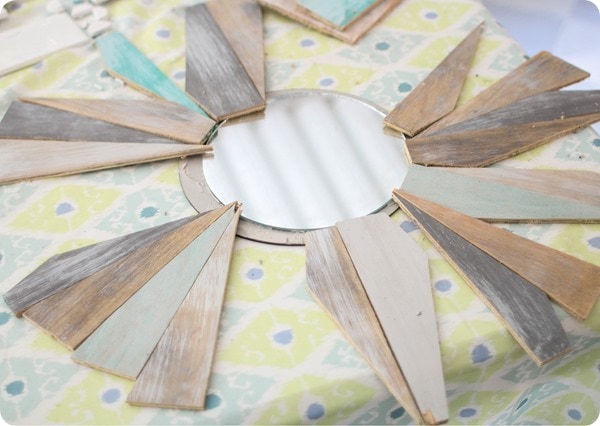 arranging wood to create a sunburst mirror