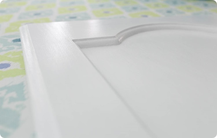 painted cabinet door with a smooth white paint finish.