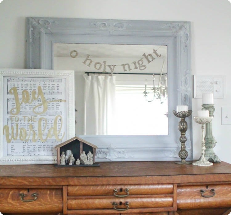 Mirror with O Holy Night banner, glitter nativity, and Joy to the World print.