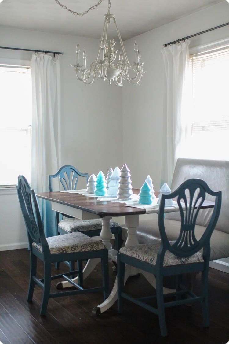 Dining table with glass Christmas tree centerpiece.