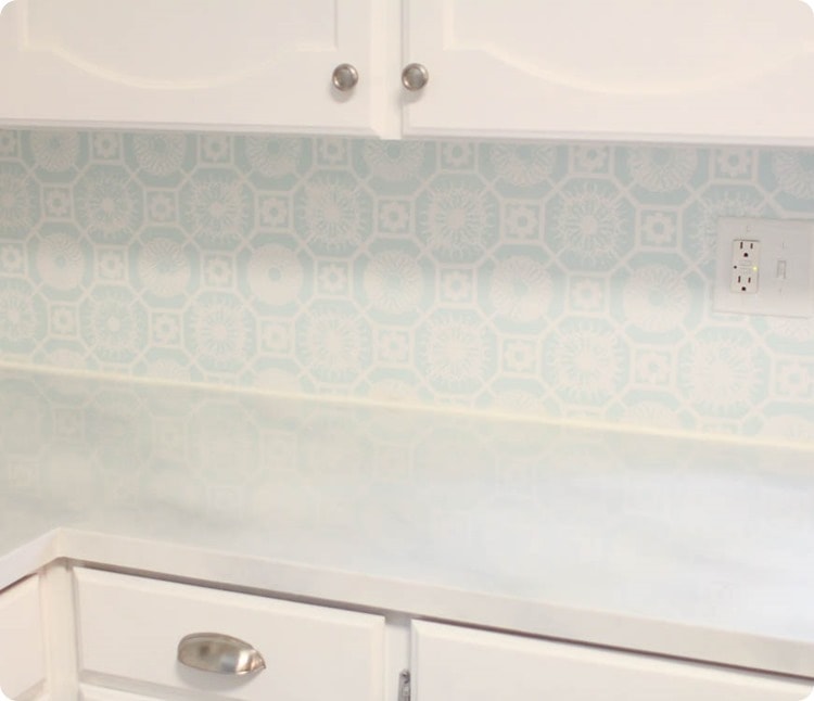 painted countertop, stenciled backsplash, and painted cabinets