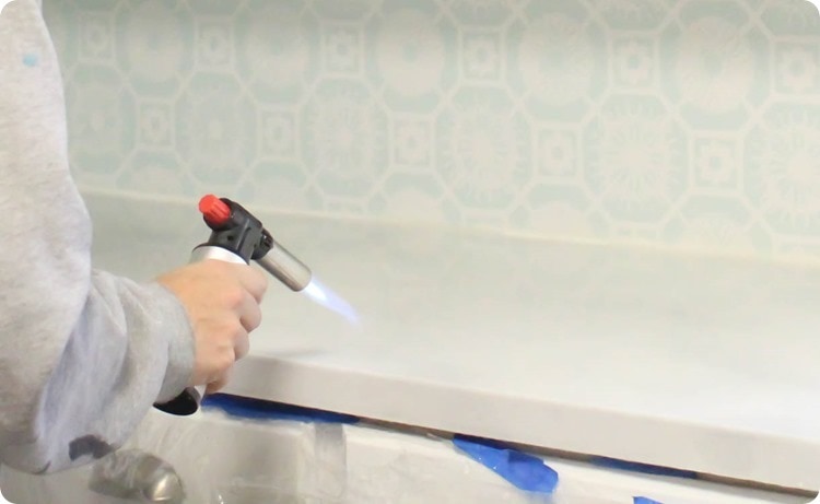 Using a butane torch to remove bubbles from resin finish on painted countertops