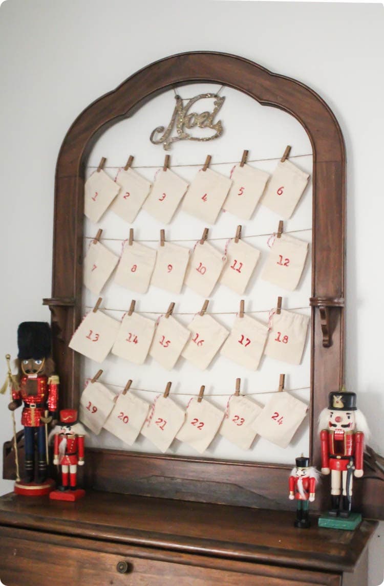 upcycled advent calendar made from an old frame and muslin favor bags.