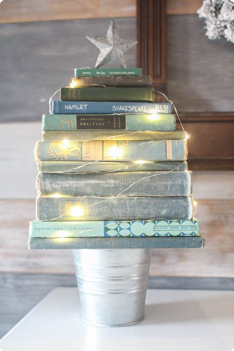 Mini Christmas tree made from a stack of vintage books and a small bucket.