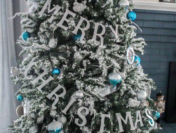 Christmas tree with banner spelling Merry Christmas.