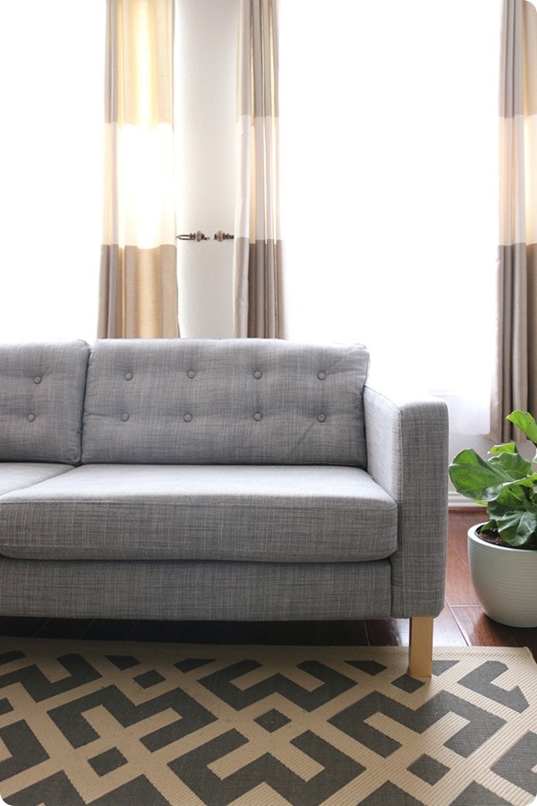 gray IKEA sofa with DIY tufted cushions.