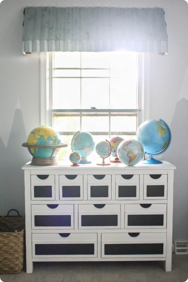 DIY farmhouse window awning with vintage dresser and globes