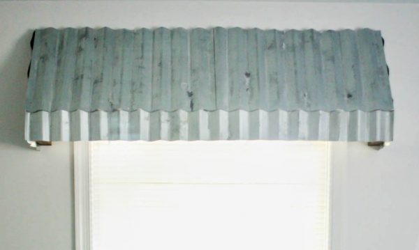 DIY metal window awnings made with corrugated metal roofing aged with toilet cleaner and steel wool.