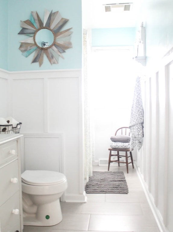 blue and white bathroom with board and batten walls