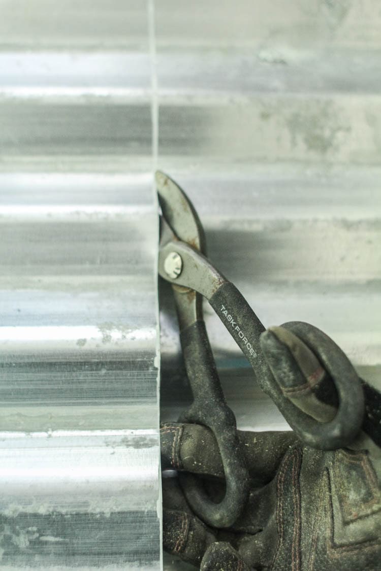 Cutting galvanized metal with tin snips.