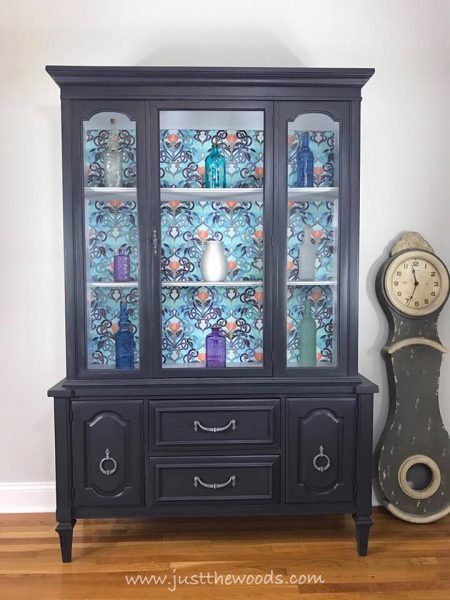 gray china cabinet with decoupage background