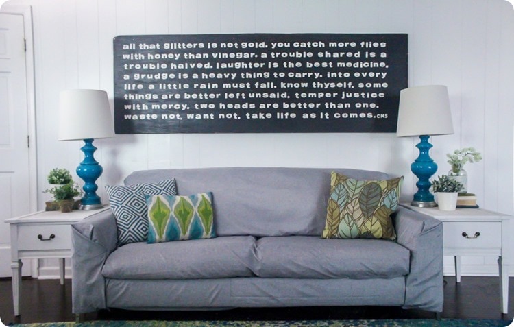 gray couch and oversized wood sign