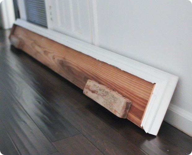 old mantel with two pieces of wood attached below for attaching to fireplace.