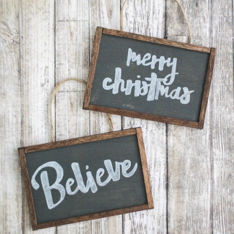 small chalkboard Christmas ornaments that say merry christmas and believe.