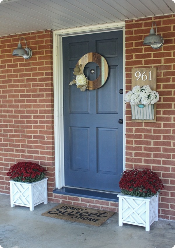  brick ranch with mums, wood wreath and door sign