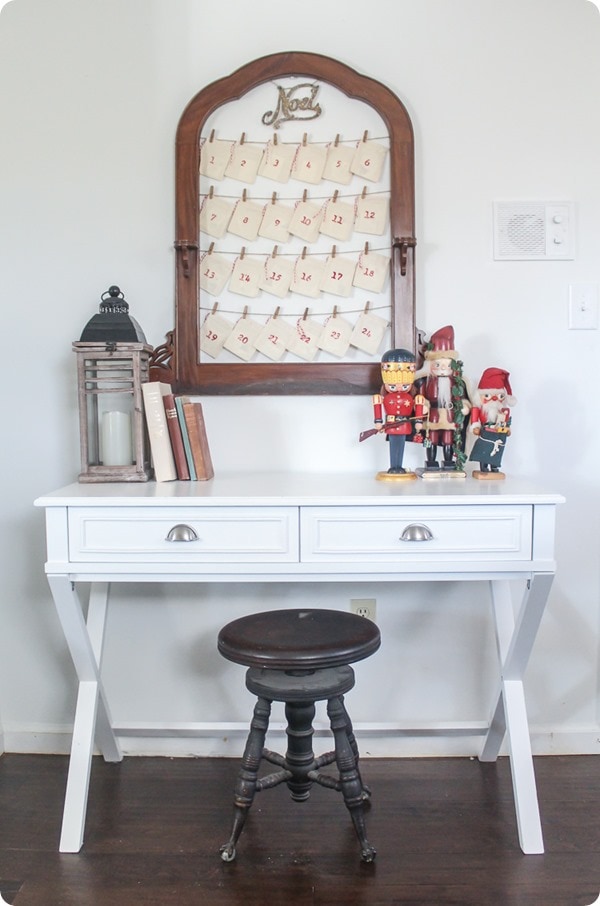 diy hanging advent calendar next to nutcrackers on small table in dining room.