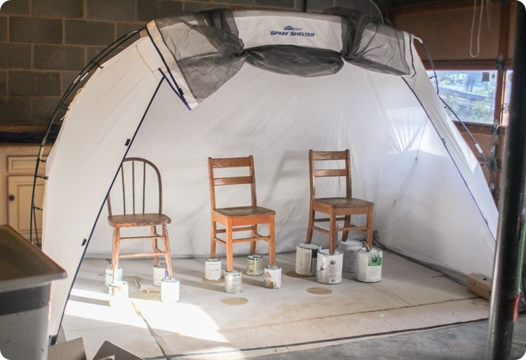 spray shelter tent set up with 3 chairs for painting.
