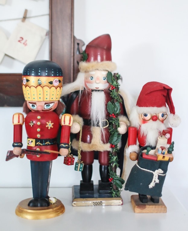 Three wooden nutcrackers - a Christmas soldier and two vintage Santas.