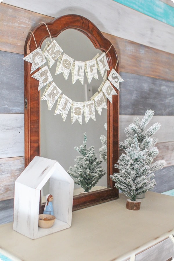 Simple diy christmas decor in entry with wood plank wall, diy merry christmas banner, and peg doll nativity.