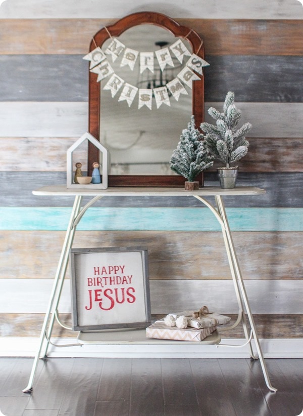 Simple diy christmas decor in entry with wood plank wall, happy birthday jesus sign and diy merry christmas banner