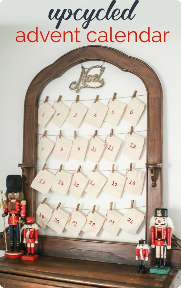 DIY reusable advent calendar made from an old frame next to nutcrackers.