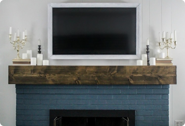 how to make a diy tv frame diy wood tv frame hanging over fireplace with diy mantel.