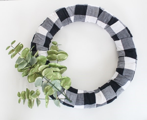 adding eucalytpus leaves to wreath